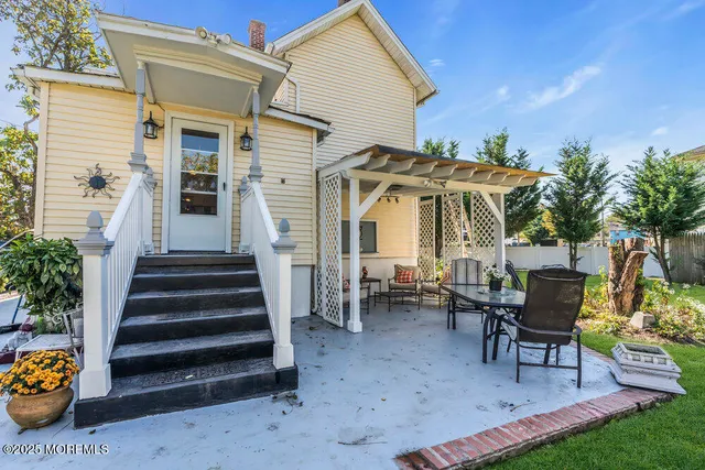 a view of a house with backyard and sitting area