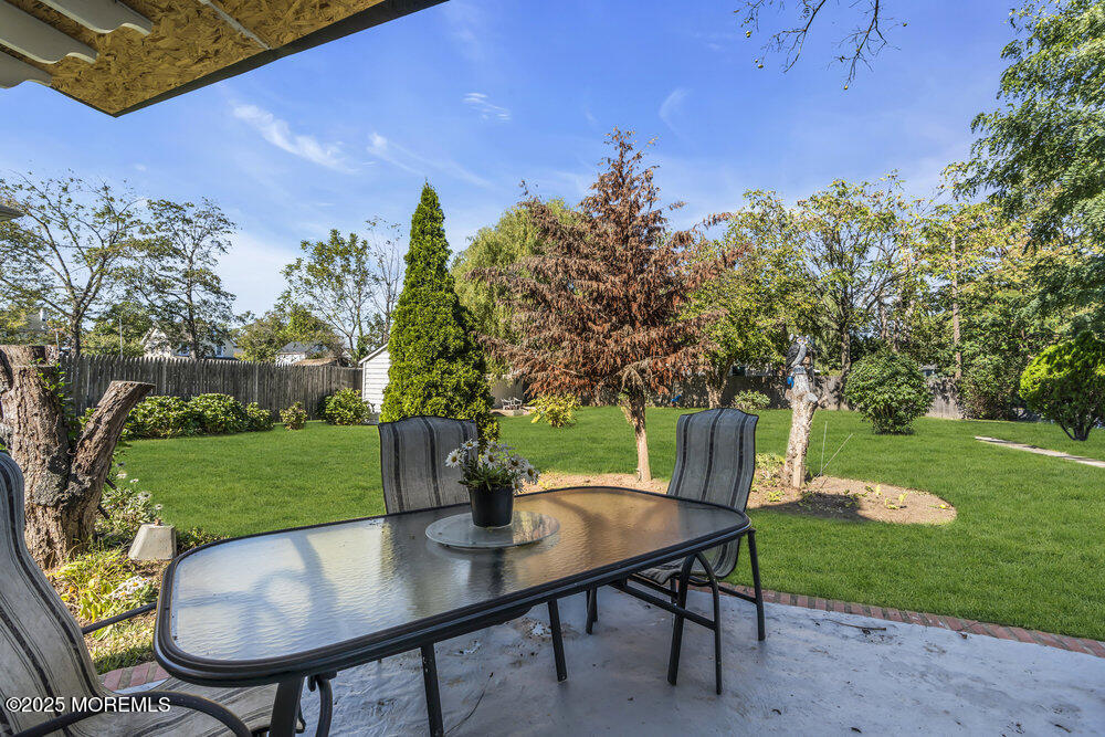 401 Joline Avenue Long Branch, NJ 07740 - Photo 22 of 30 a view of a backyard with table and chairs potted plants and tree