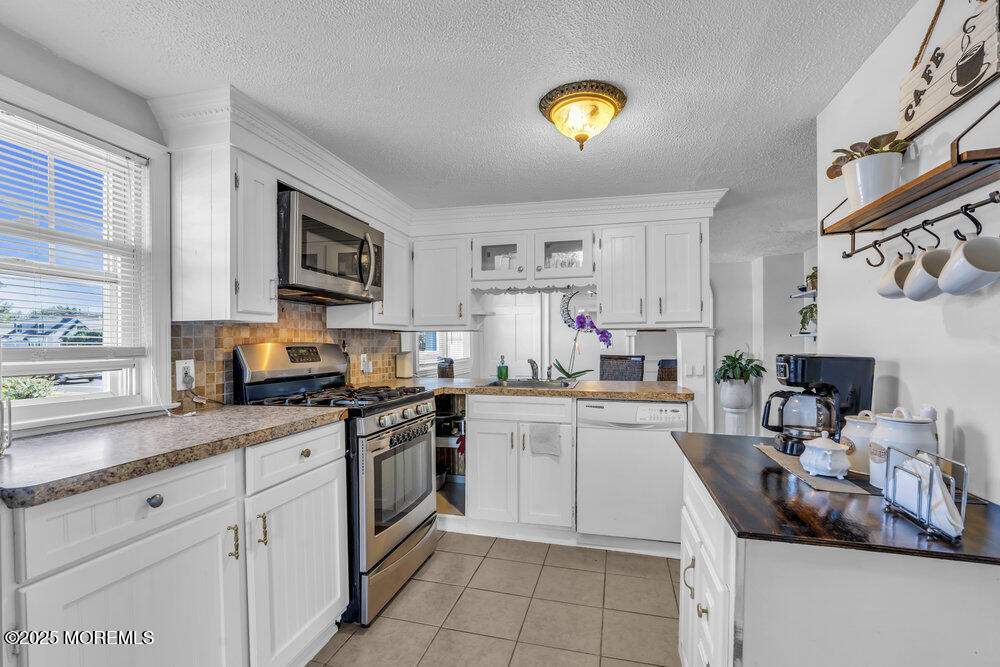 401 Joline Avenue Long Branch, NJ 07740 - Photo 8 of 30 a kitchen with a sink cabinets and window