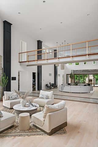 a living room with patio furniture and a fireplace