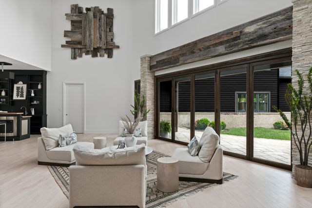 a living room with furniture and a floor to ceiling window