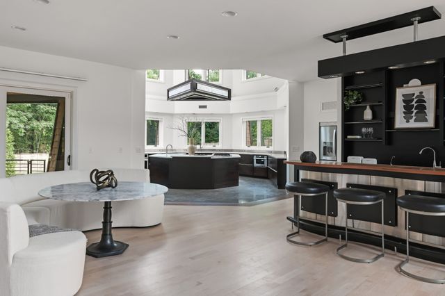 a living room with furniture a flat screen tv and windows