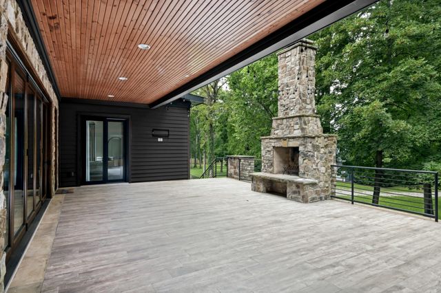 a bathroom with a granite countertop sink a mirror and shower