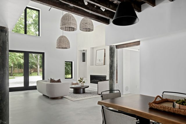 a kitchen with stainless steel appliances a table and chairs in it