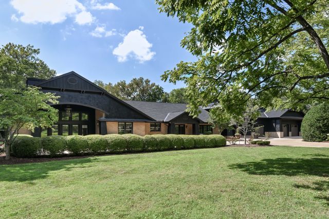 a view of backyard with outdoor seating and green space