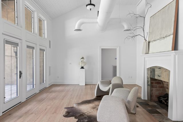 a view of a patio with table and chairs potted plants and large tree