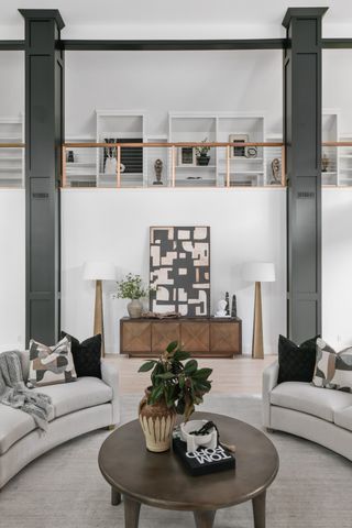 a living room with furniture kitchen view and a window