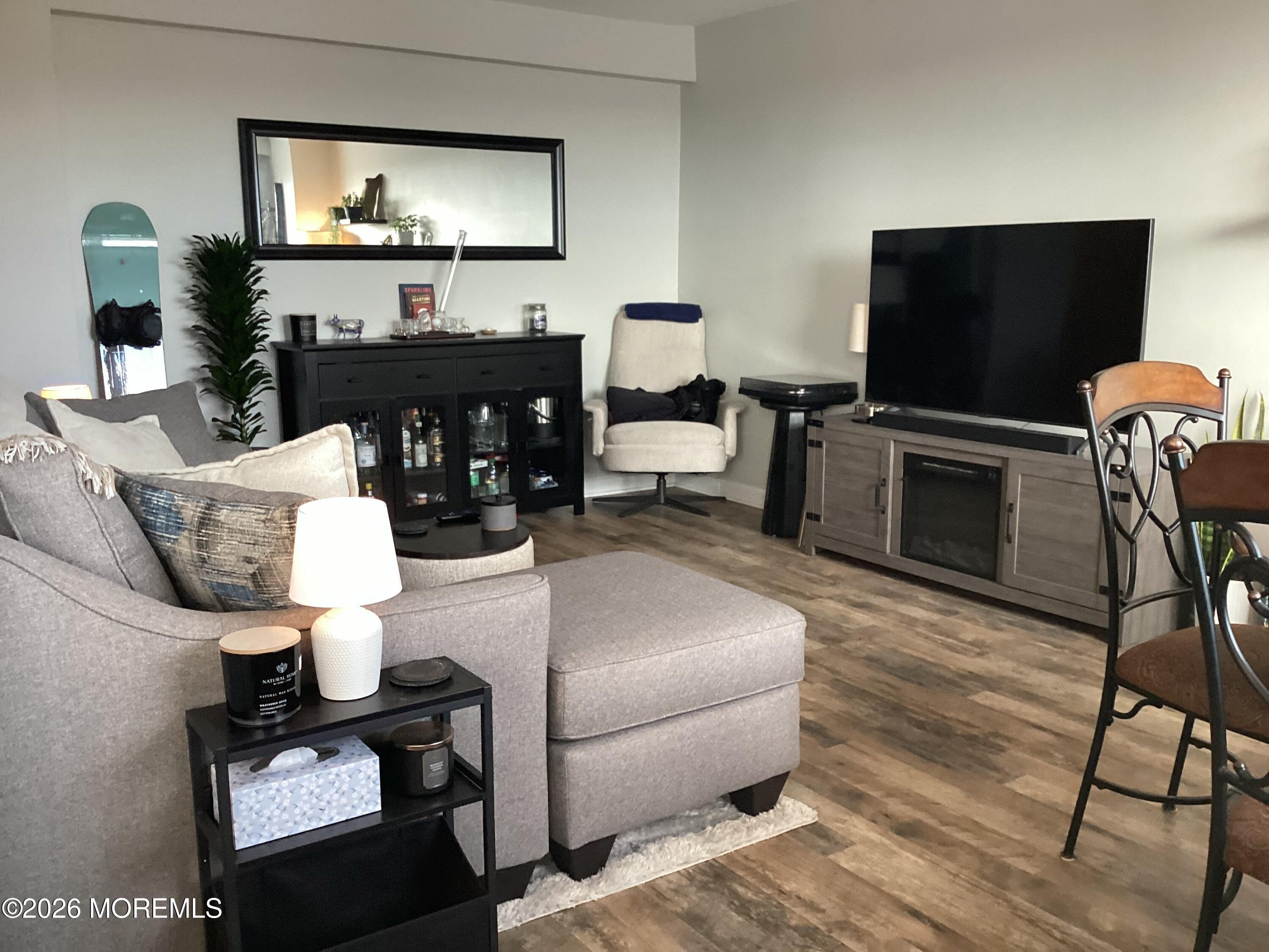 28 Riverside Avenue, Unit 9D Red Bank, NJ 07701 - Photo 14 of 15 a living room with furniture and a flat screen tv