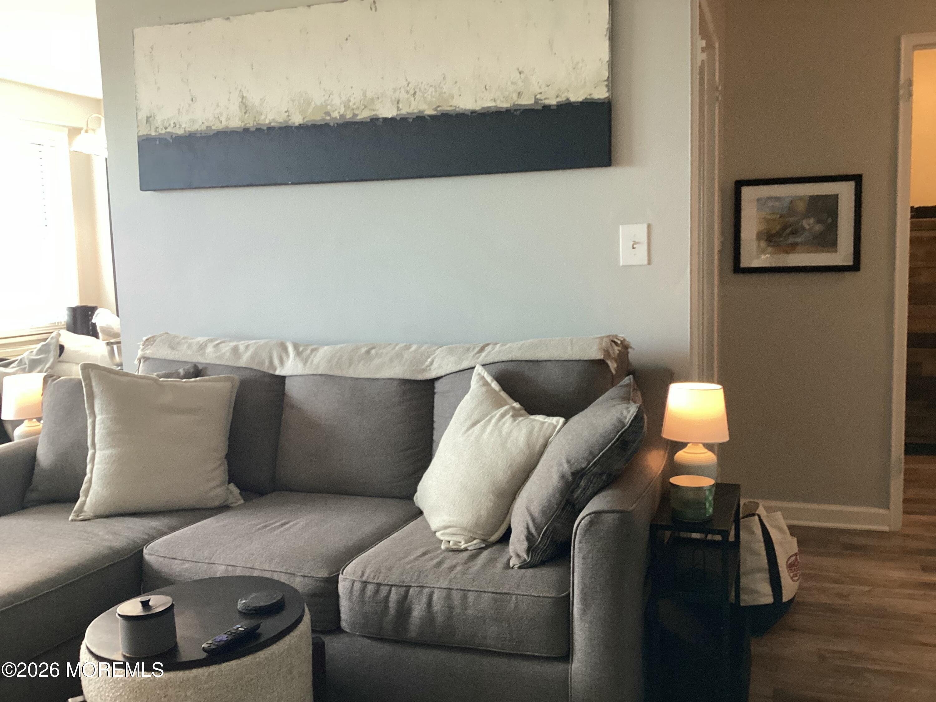 28 Riverside Avenue, Unit 9D Red Bank, NJ 07701 - Photo 2 of 15 a living room with furniture and a lamp