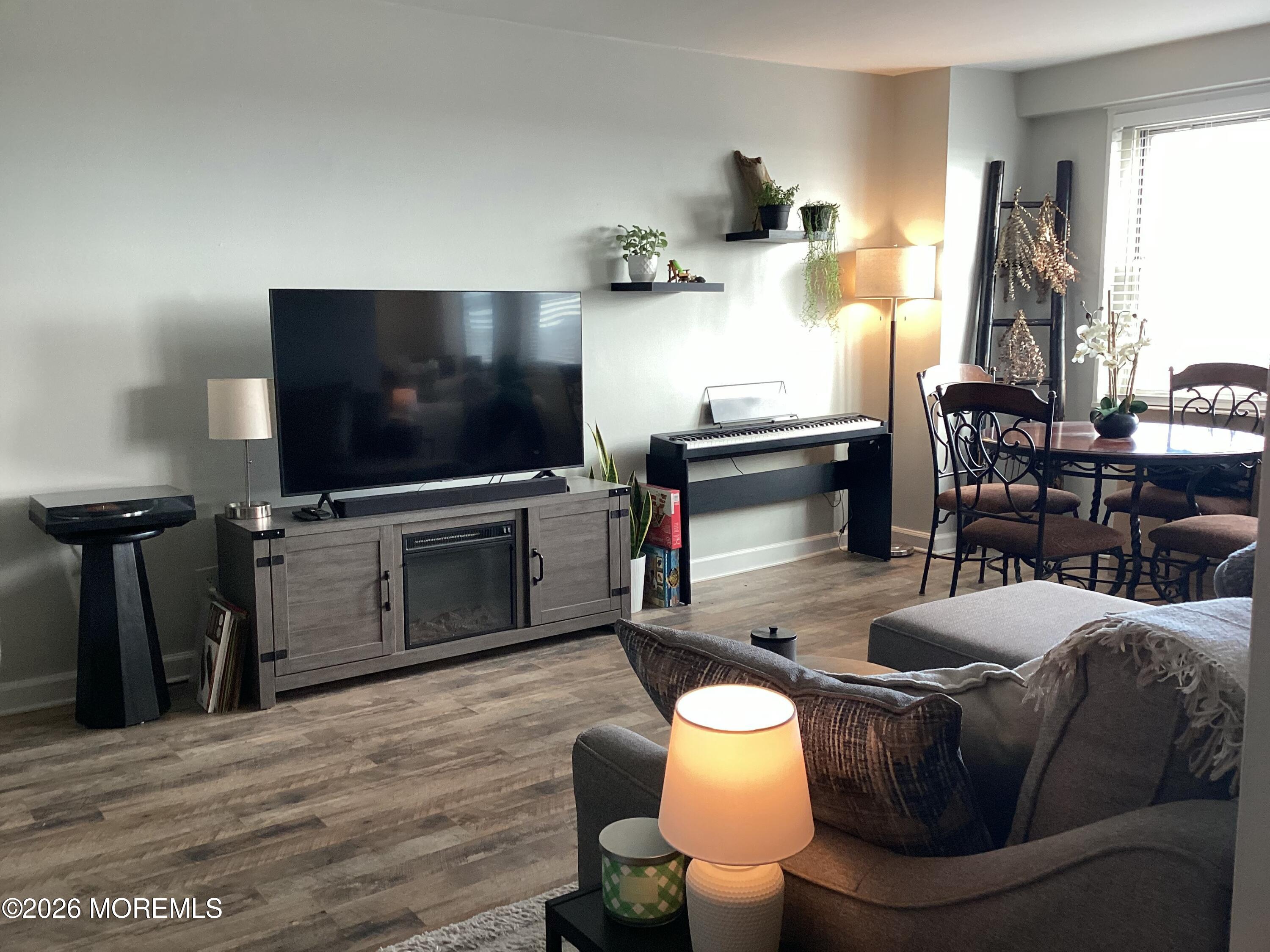 28 Riverside Avenue, Unit 9D Red Bank, NJ 07701 - Photo 3 of 15 a living room with furniture and a flat screen tv