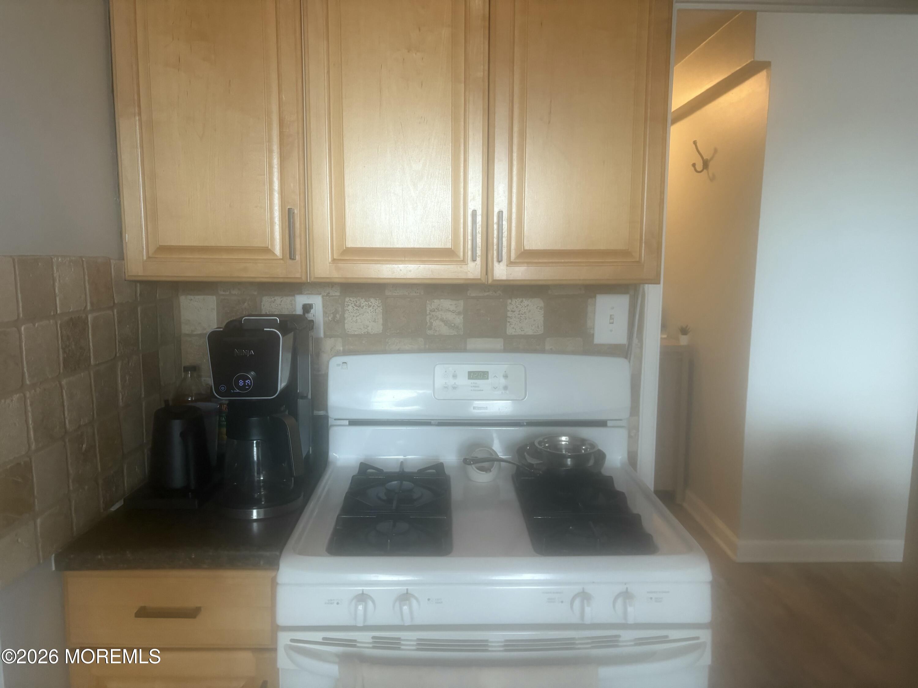 28 Riverside Avenue, Unit 9D Red Bank, NJ 07701 - Photo 6 of 15 a kitchen with a sink and cabinets