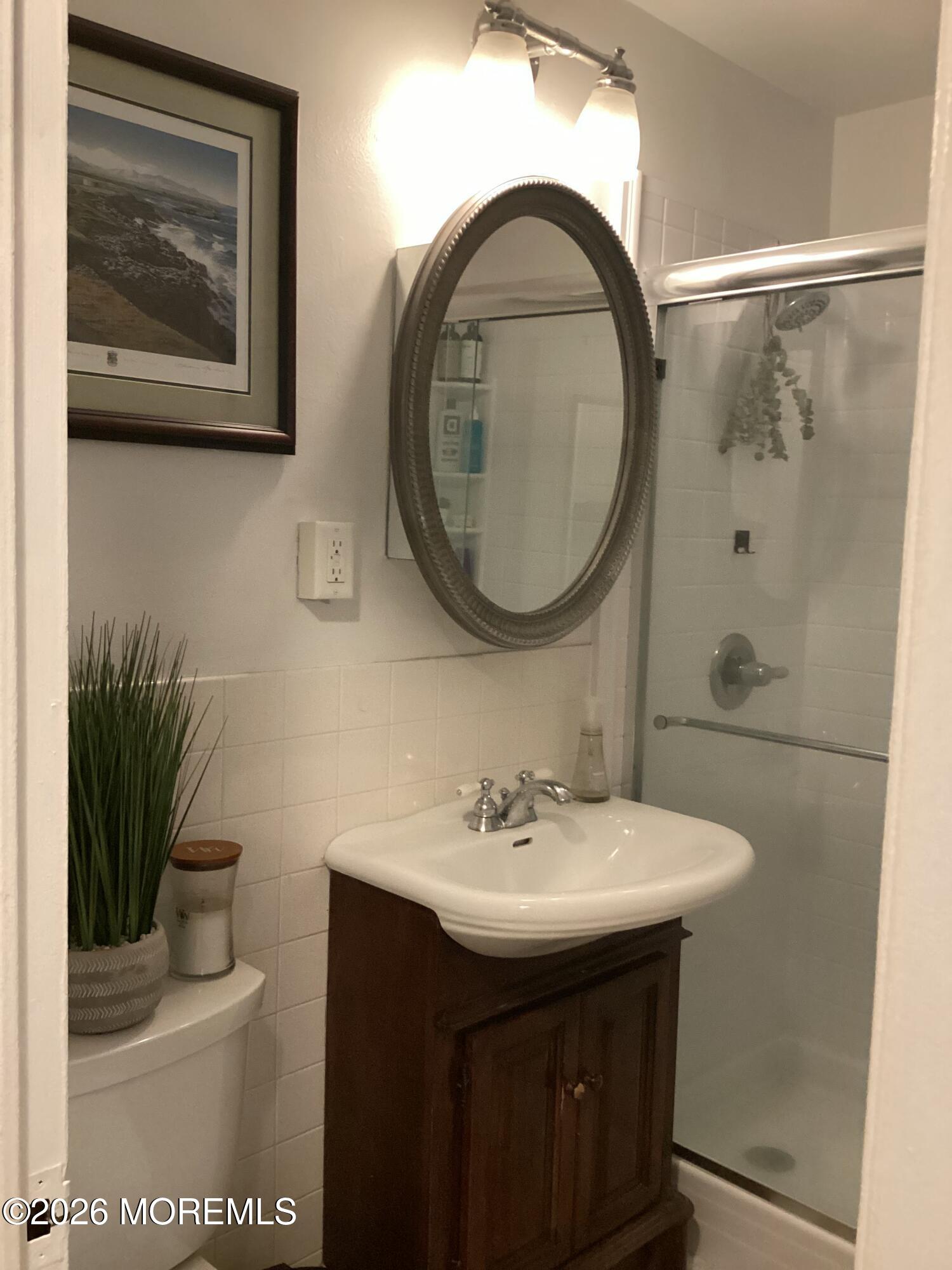 28 Riverside Avenue, Unit 9D Red Bank, NJ 07701 - Photo 7 of 15 a bathroom with a sink and a mirror