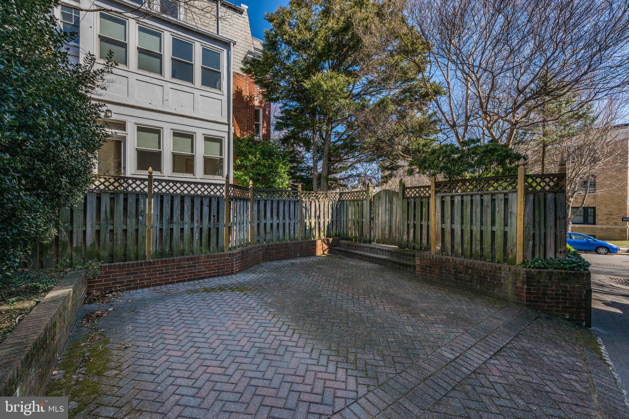 2862 28th Street Northwest Washington, DC 20008 - Photo 25 of 26 a view of a brick house with a large window and wooden fence