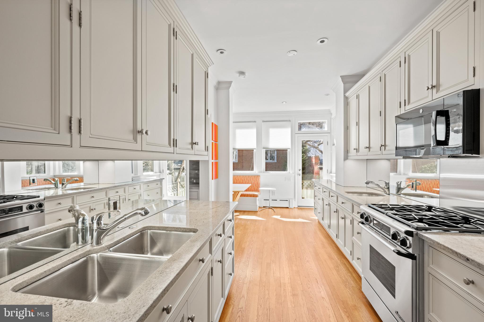 2862 28th Street Northwest Washington, DC 20008 - Photo 8 of 26 a kitchen with stainless steel appliances granite countertop a sink stove and refrigerator