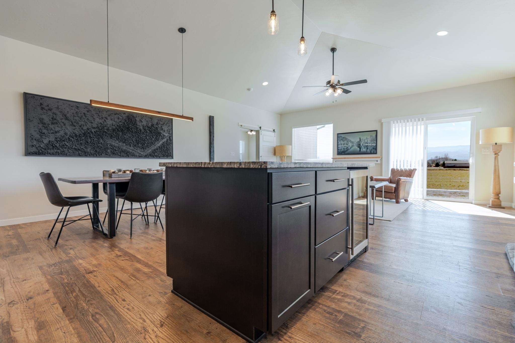 1301 M Road Loma, CO 81524 - Photo 19 of 32 a kitchen with stainless steel appliances granite countertop a refrigerator a sink dishwasher a stove and a dining table with wooden floor
