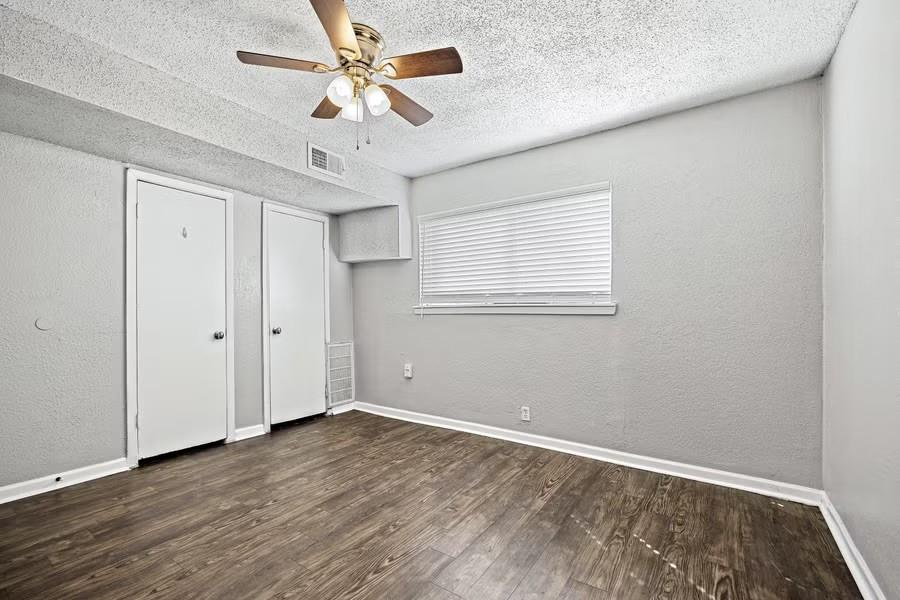 5414 Reiger Avenue, Unit 8 Dallas, TX 75214 - Photo 7 of 14 wooden floor in an empty room with a window