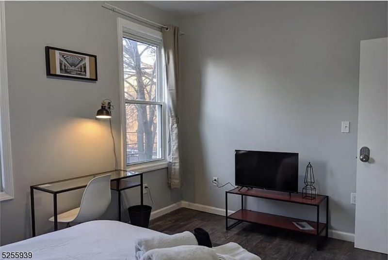 16 Alexander Street, Unit 2 Newark, NJ 07106 - Photo 6 of 8 a living room with furniture and a flat screen tv