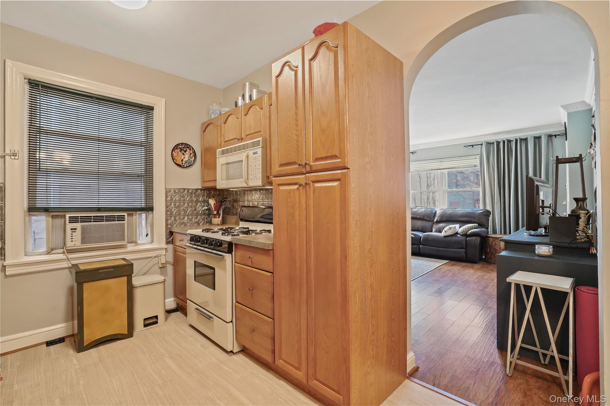 43-06 57th Street Queens, NY 11377 - Photo 12 of 21 a kitchen with cabinets and appliances