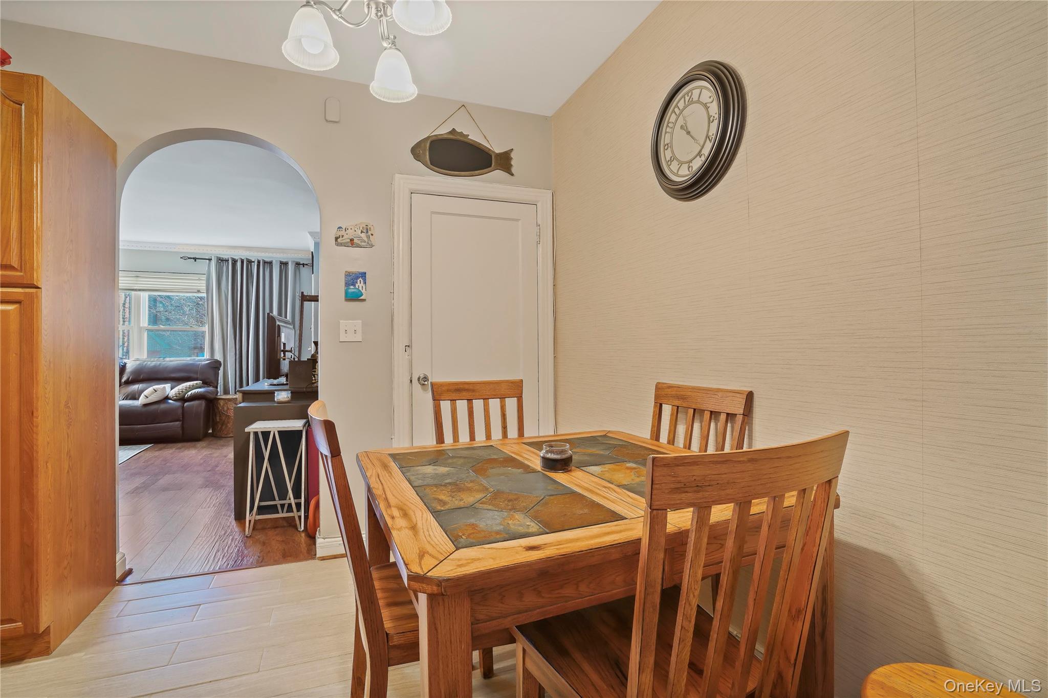 43-06 57th Street Queens, NY 11377 - Photo 15 of 21 a view of a dining room with furniture and a chandelier