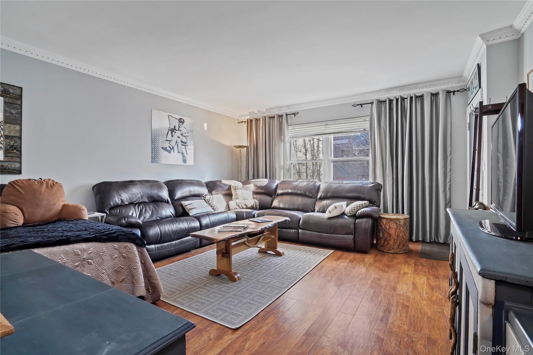 43-06 57th Street Queens, NY 11377 - Photo 18 of 21 a living room with furniture wooden floor and a flat screen tv