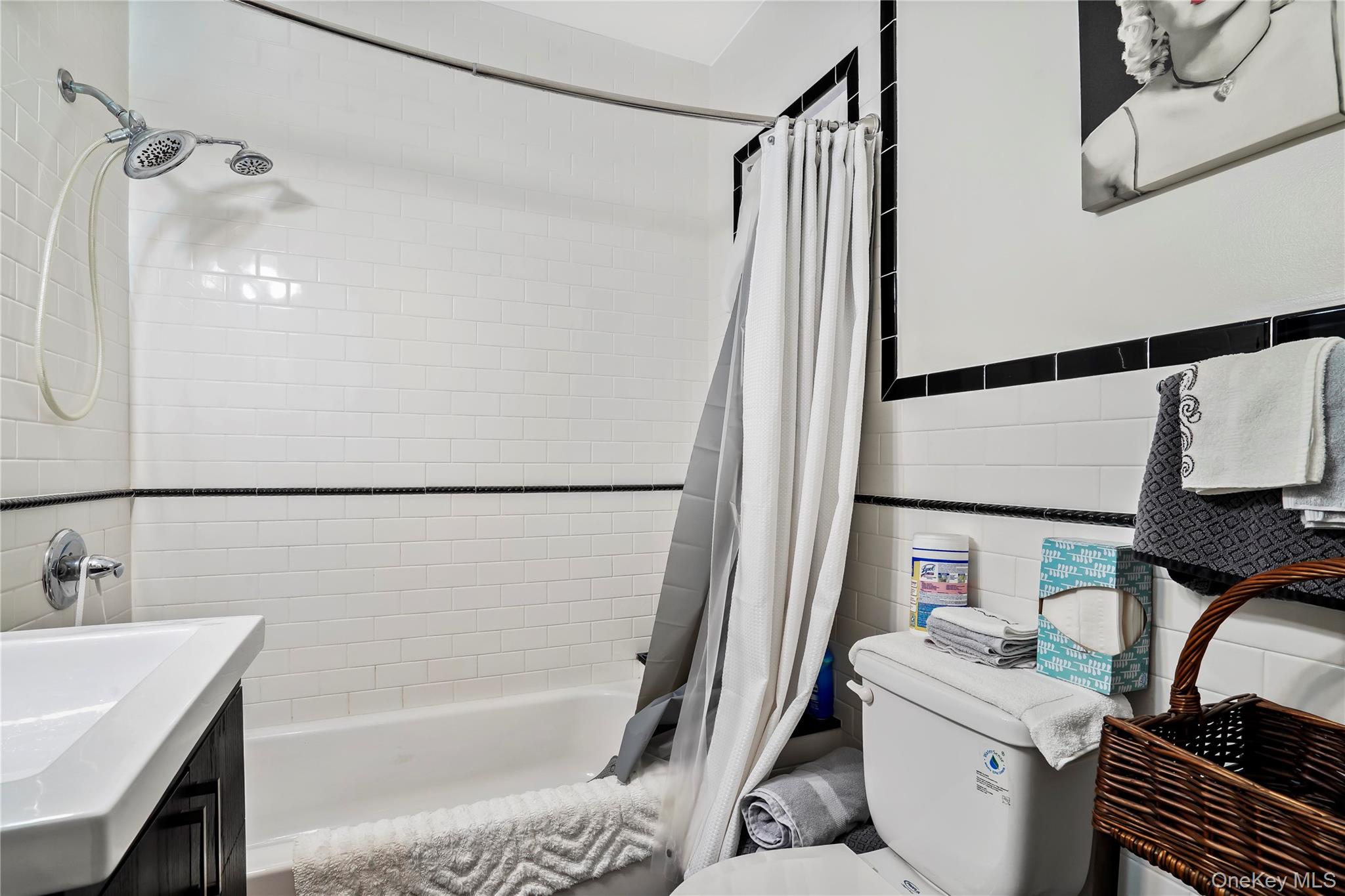 43-06 57th Street Queens, NY 11377 - Photo 8 of 21 a bathroom with a sink a bathtub and a shower