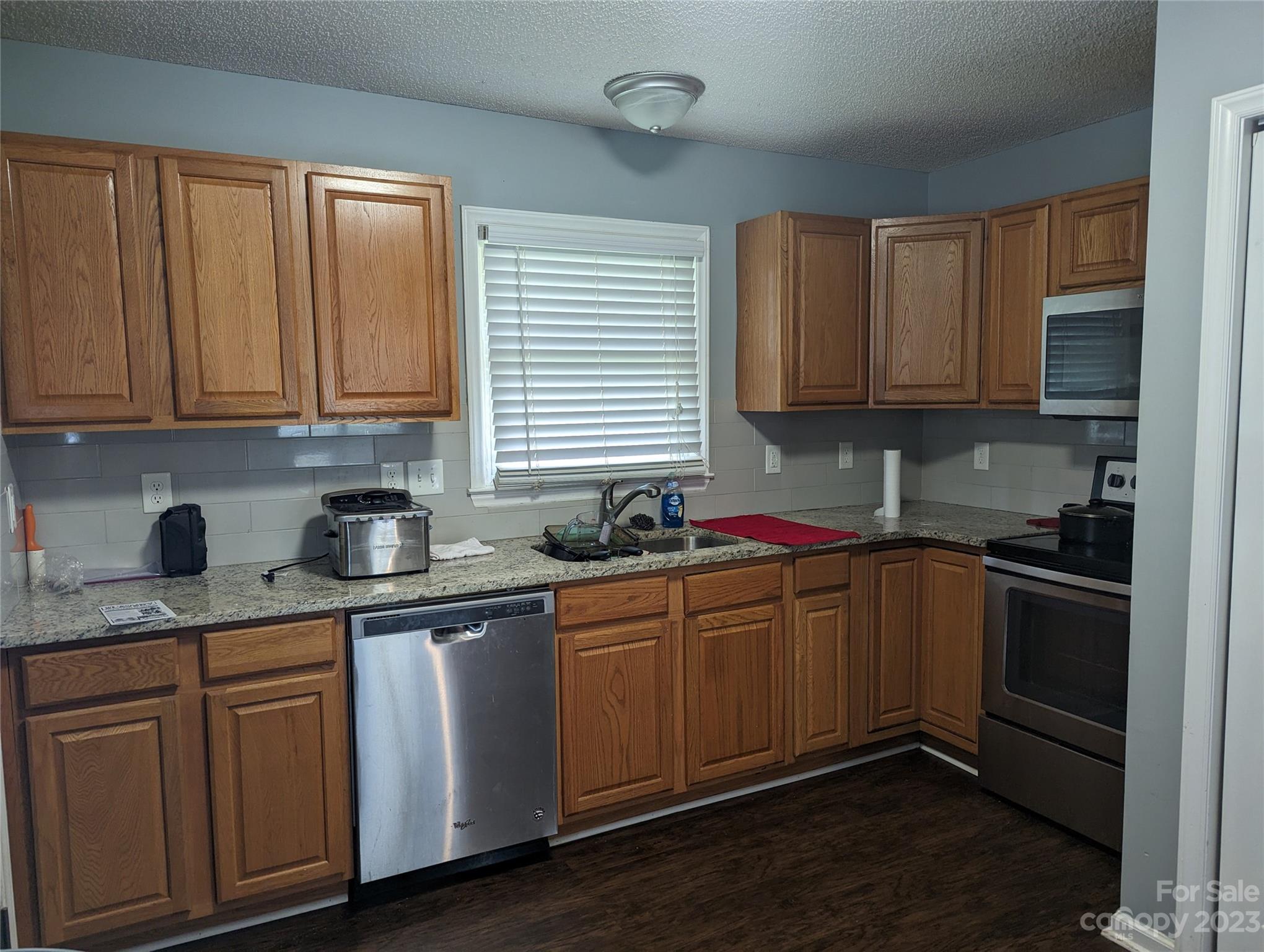 3525 Hickory Place Salisbury, NC 28144 - Photo 6 of 33 a kitchen with granite countertop wooden cabinets stainless steel appliances and a window