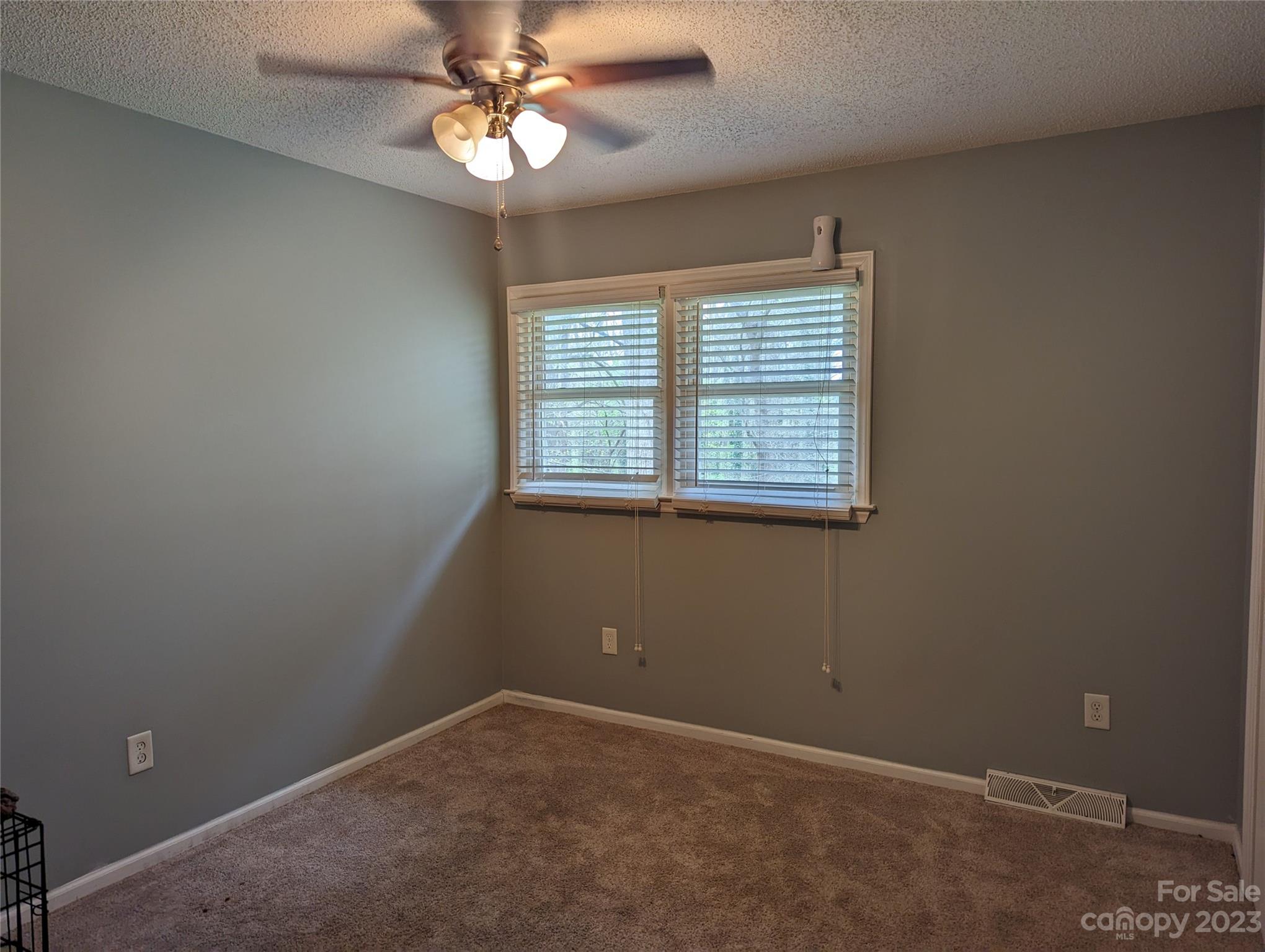 3525 Hickory Place Salisbury, NC 28144 - Photo 9 of 33 an empty room with a window and a fan