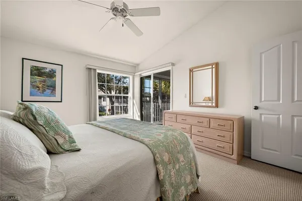 a spacious bedroom with a bed and a window