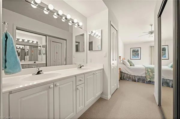 a bedroom with a bed and ceiling fan