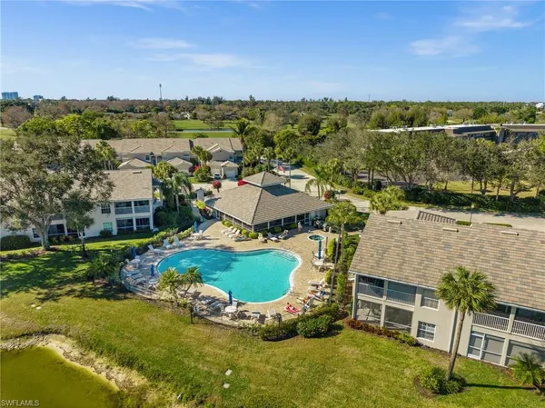 an aerial view of house with yard swimming pool and outdoor seating