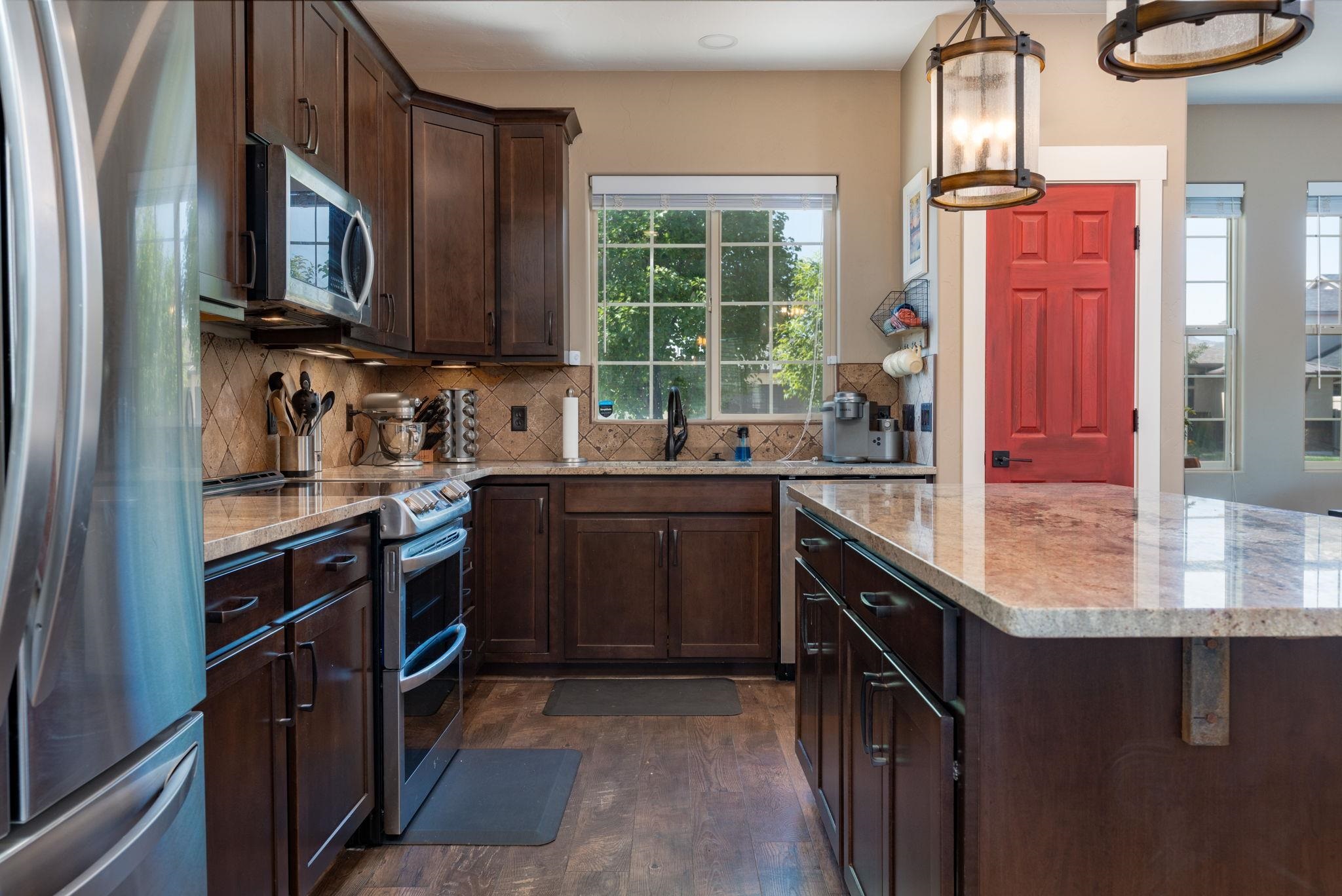 1139 Aspen Village Loop Fruita, CO 81521 - Photo 11 of 21 a kitchen with stainless steel appliances granite countertop a sink stove and cabinets