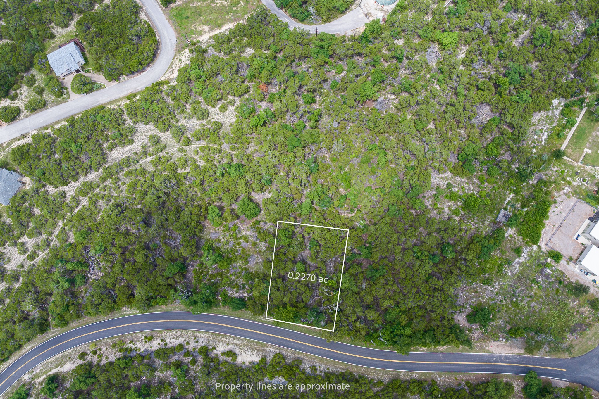 8220 Bar K Ranch Road Lago Vista, TX 78645 - Photo 1 of 8 Secure this verdant lot, perfectly positioned for future development, nestled beside a quiet winding road.