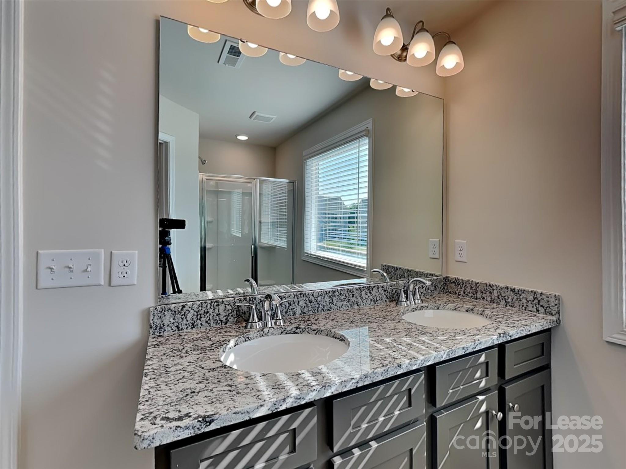 212 Queenshall Road Mooresville, NC 28117 - Photo 12 of 15 a bathroom with a granite countertop sink a large mirror and vanity