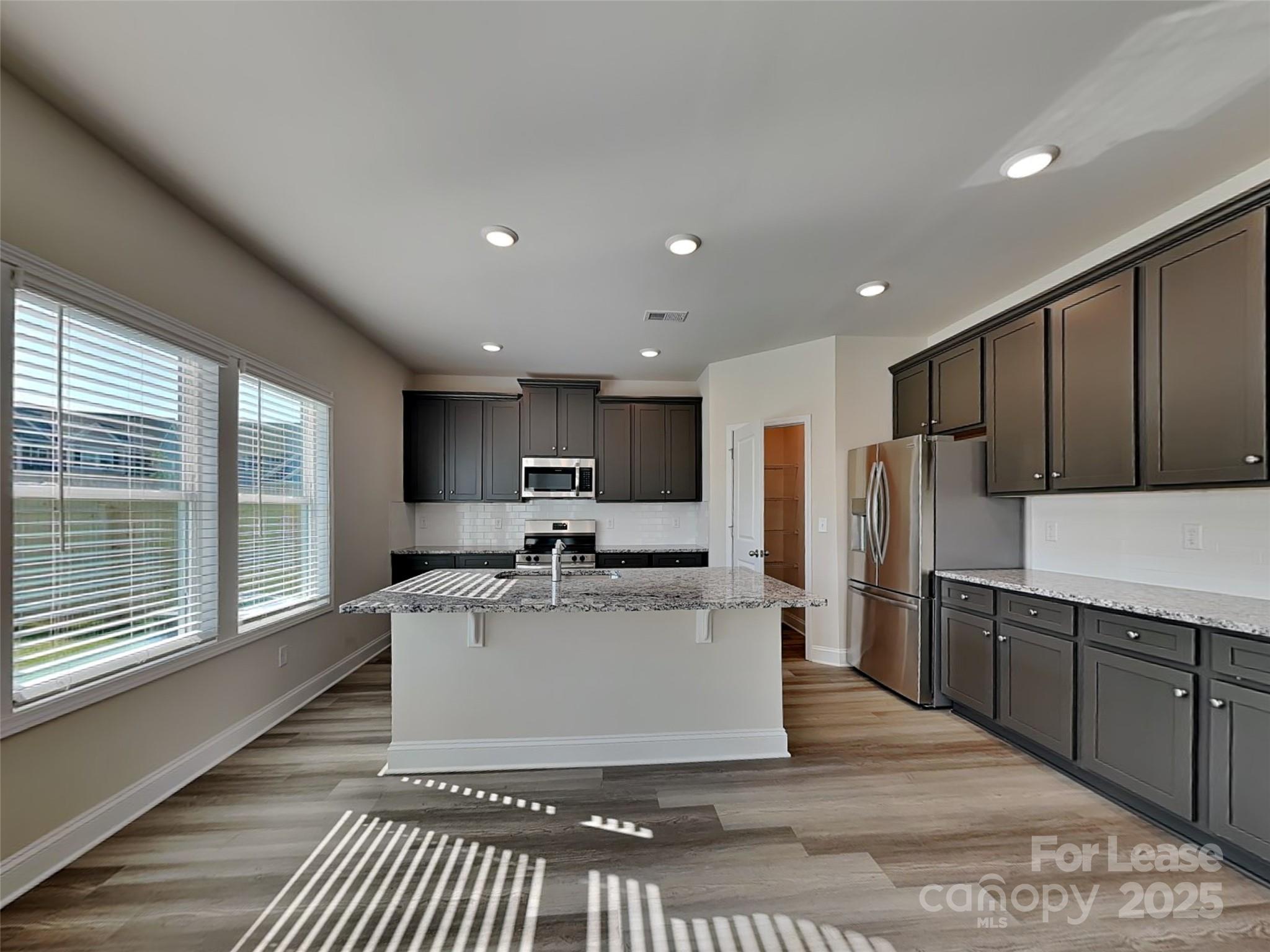 212 Queenshall Road Mooresville, NC 28117 - Photo 2 of 15 a large white kitchen with a large window