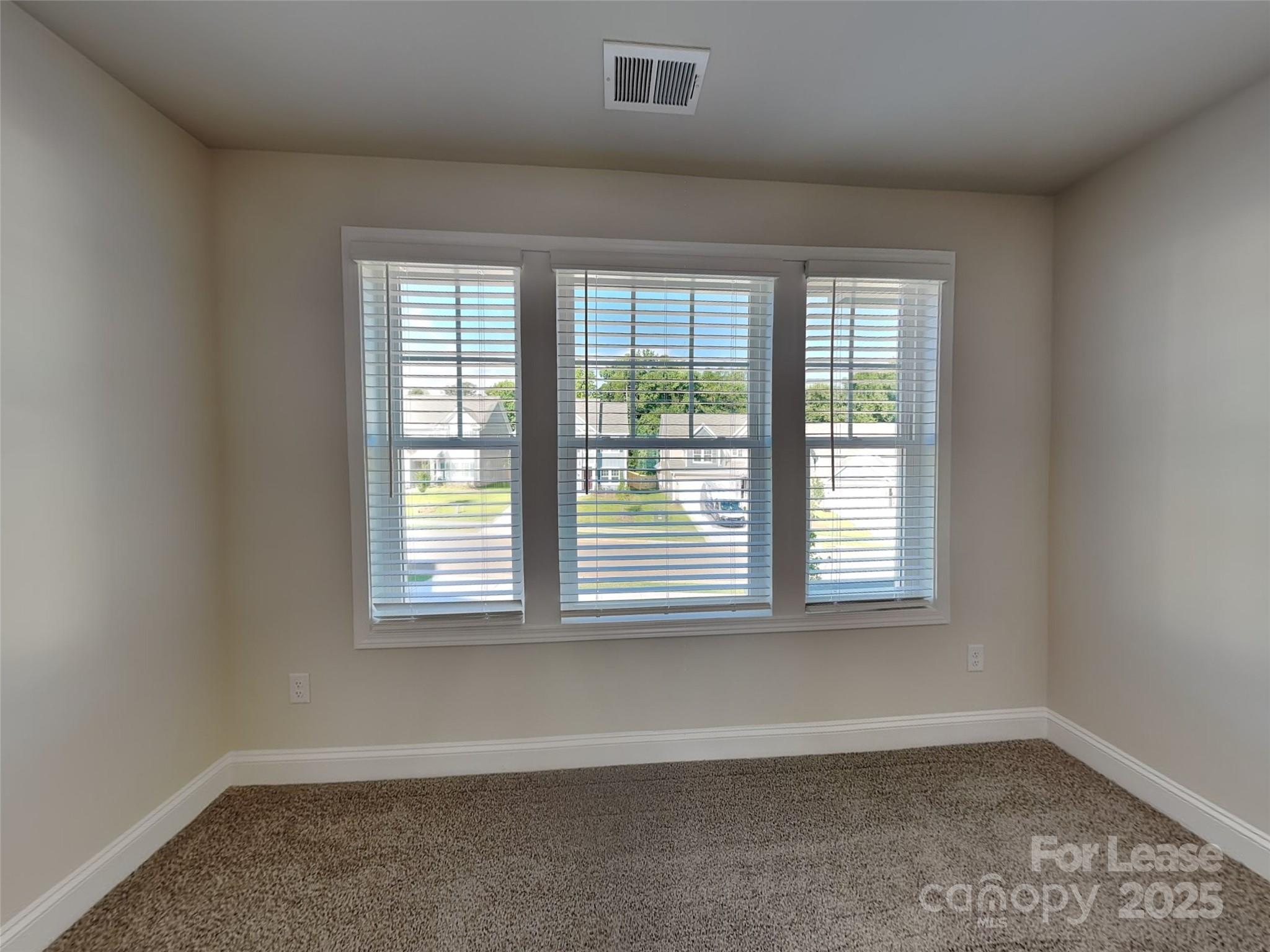 212 Queenshall Road Mooresville, NC 28117 - Photo 7 of 15 a view of an empty room with a window