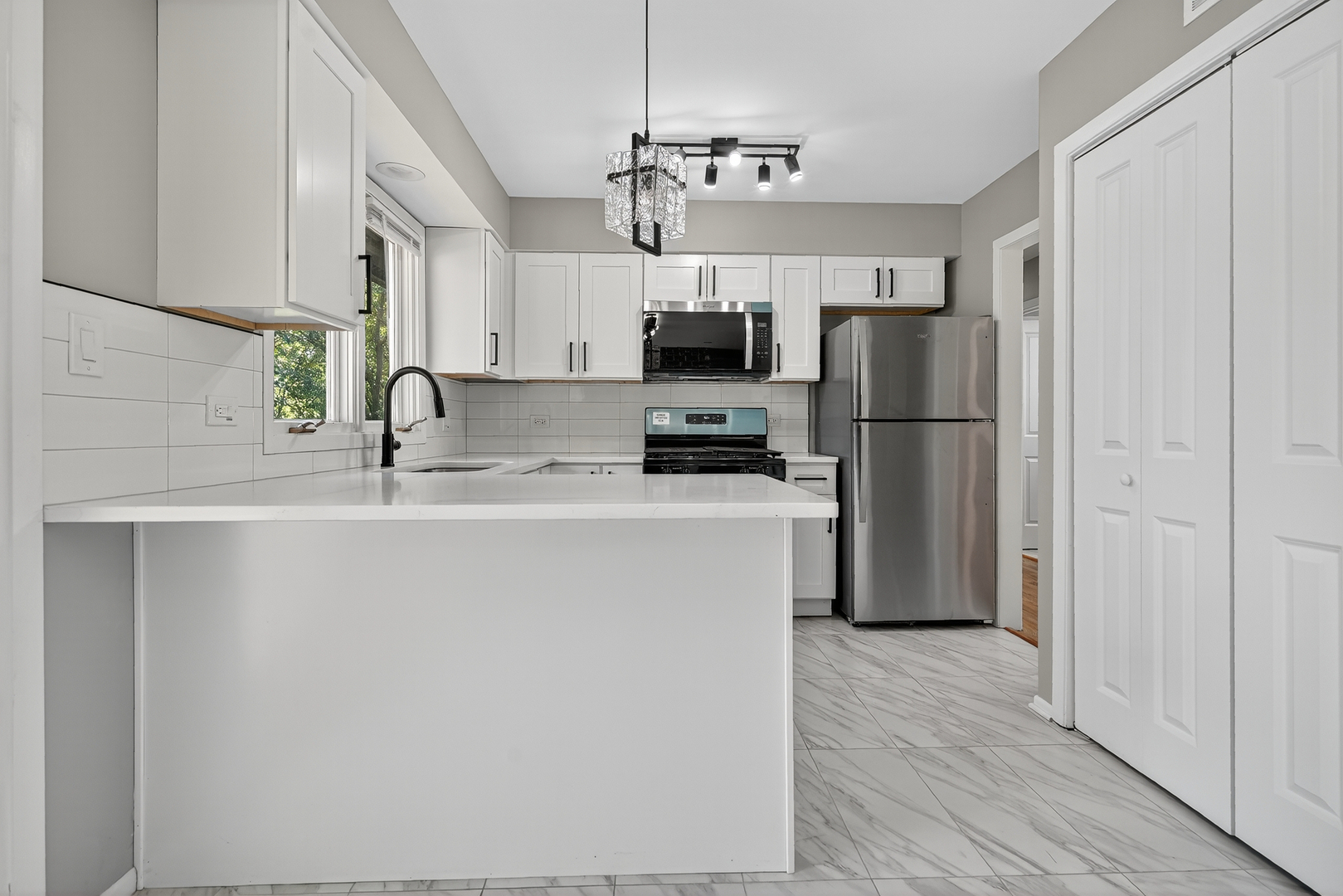 1245 Winaki Trail Algonquin, IL 60102 - Photo 17 of 39 a kitchen with kitchen island a refrigerator a sink dishwasher a oven with a dining table and chairs