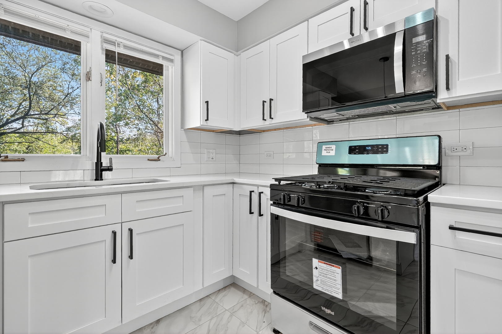 1245 Winaki Trail Algonquin, IL 60102 - Photo 18 of 39 a kitchen with cabinets stainless steel appliances and a window