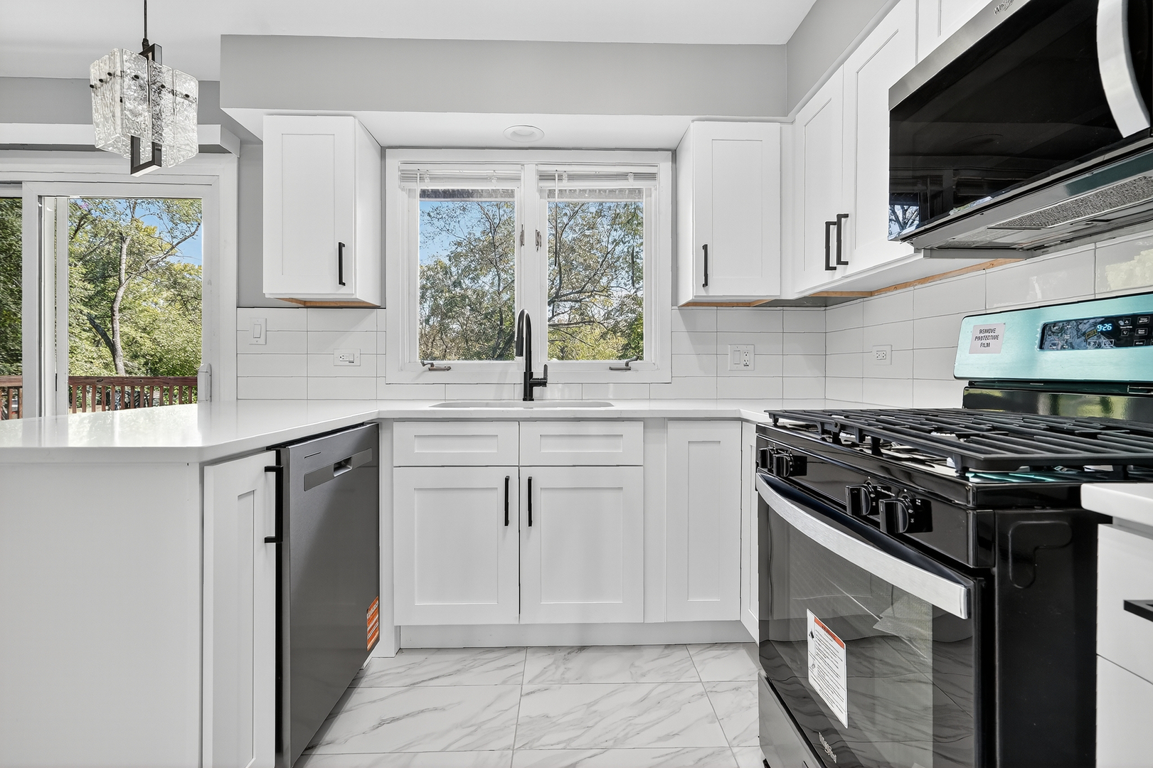 1245 Winaki Trail Algonquin, IL 60102 - Photo 19 of 39 a kitchen with stainless steel appliances white cabinets and a stove top oven