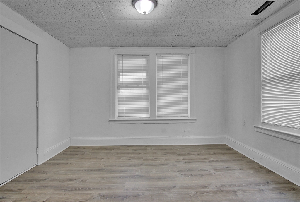 1397 Worcester Street, Unit 2 Springfield, MA 01151 - Photo 13 of 15 wooden floor in an empty room with a window