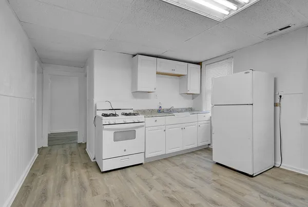 a kitchen with a white cabinets and white appliances