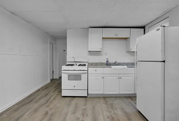 a utility room with cabinets washer and dryer