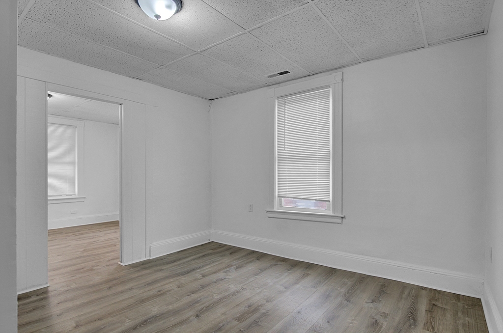 1397 Worcester Street, Unit 2 Springfield, MA 01151 - Photo 4 of 15 an empty room with wooden floor and windows
