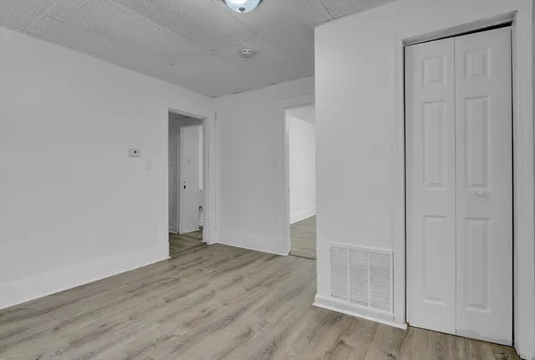 an empty room with wooden floor