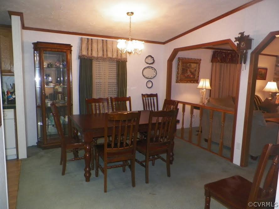 4619 Venable Road Kents Store, VA 23084 - Photo 9 of 21 a view of a dining room with furniture and a chandelier