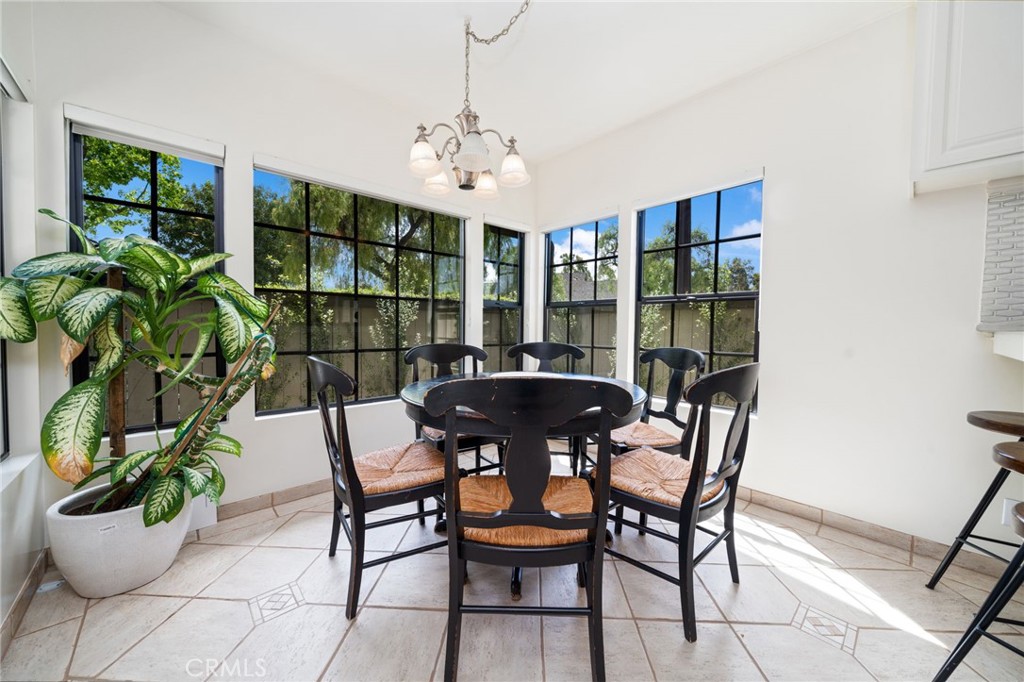 49 Pinewood, Unit 25 Irvine, CA 92604 - Photo 11 of 42 a view of a dining room with furniture and chandelier
