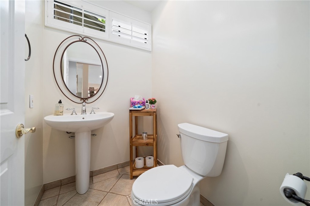 49 Pinewood, Unit 25 Irvine, CA 92604 - Photo 19 of 42 a bathroom with a toilet a sink and mirror