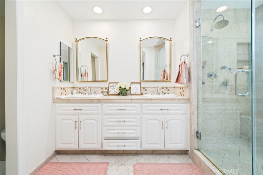 49 Pinewood, Unit 25 Irvine, CA 92604 - Photo 24 of 42 a bathroom with a double vanity sink mirror and double