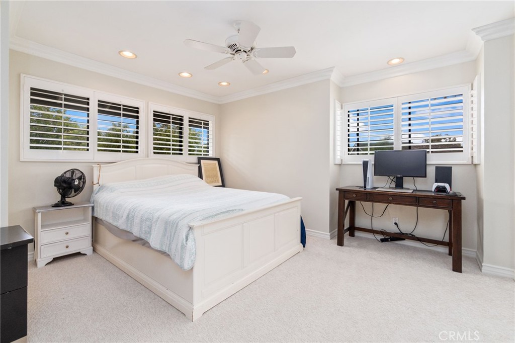 49 Pinewood, Unit 25 Irvine, CA 92604 - Photo 25 of 42 a bedroom with a bed and a chandelier