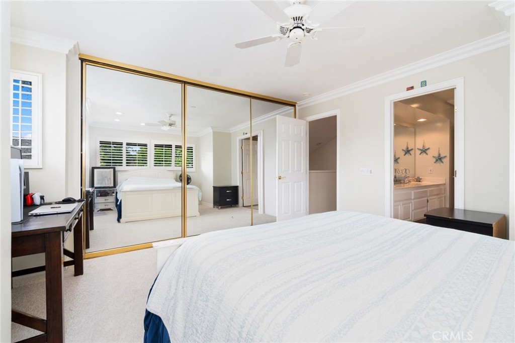 49 Pinewood, Unit 25 Irvine, CA 92604 - Photo 26 of 42 a spacious bedroom with a bed and a chandelier