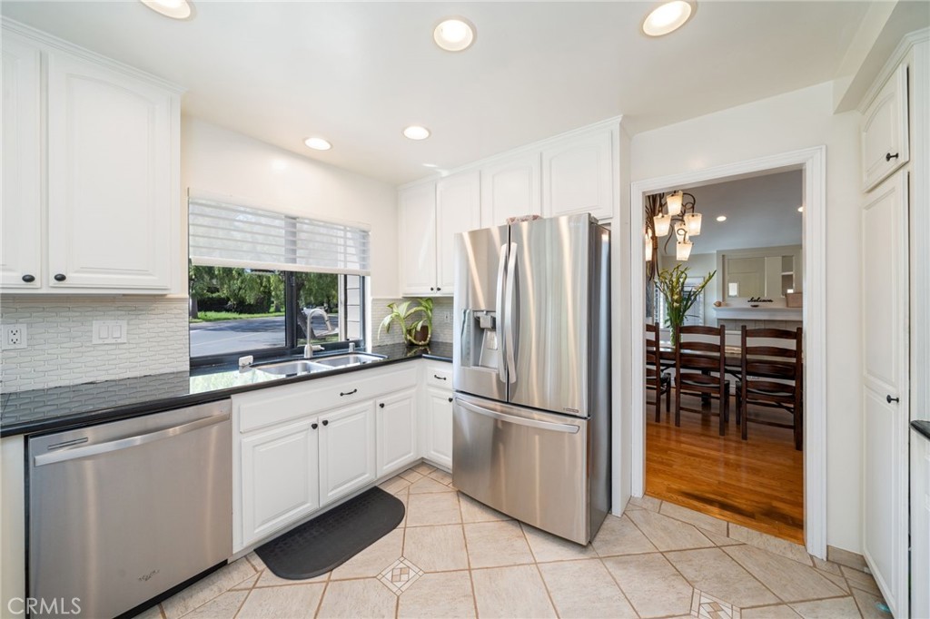 49 Pinewood, Unit 25 Irvine, CA 92604 - Photo 6 of 42 a kitchen with stainless steel appliances a refrigerator sink and cabinets